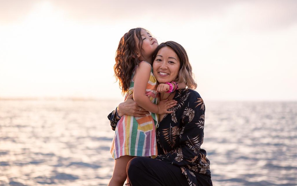 Dr Jin Ong with her daughter Violet by the sea in New Zealand