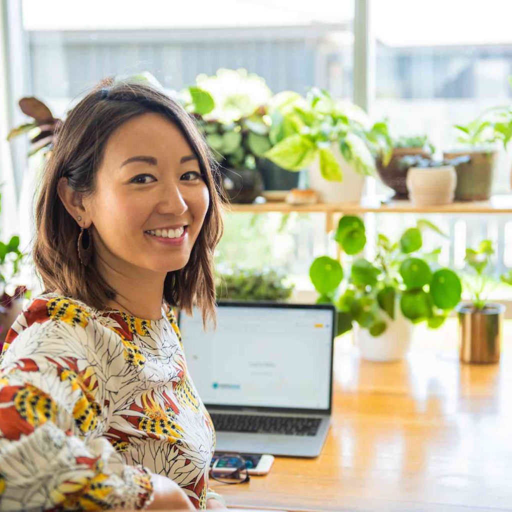 dr jin ong psychomatic and emotional healing coach at her desk in wanaka new zealand 1024x1024